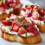 Delicious Strawberry Ricotta Bruschetta topped with fresh strawberries and creamy ricotta.