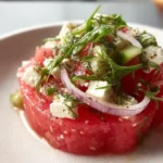 Delicious Watermelon Feta Salad with fresh greens and a mint garnish
