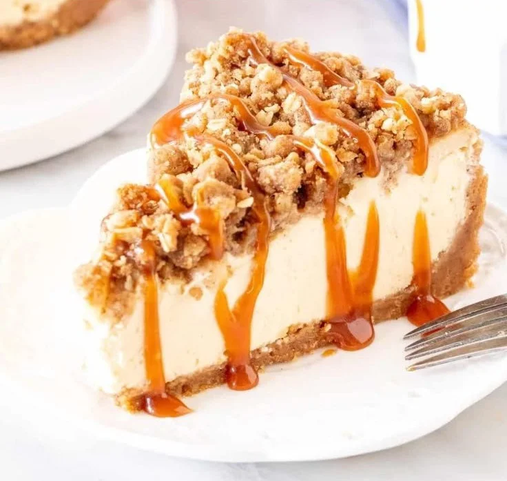 Delicious Apple Crisp Cheesecake topped with crunchy apple pieces and cinnamon.