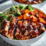 BBQ chicken sweet potato bowls topped with fresh herbs and veggies