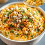 Delicious cheesy Mexican street corn dip served in a bowl with toppings
