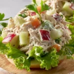 Chicken Salad with Apples 3 Delicious chicken salad with apples, walnuts, and greens served in a bowl.