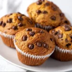 Plate of delicious banana protein muffins topped with nuts.