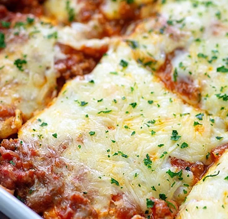 Easy cheesy ravioli lasagna with layers of cheese and sauce ready to serve.