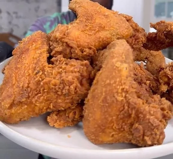 Delicious golden-brown fried chicken served with dipping sauce on a plate