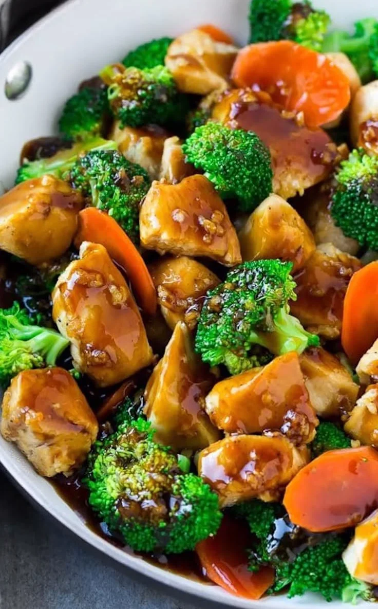 Healthy chicken stir fry in honey garlic sauce served with colorful vegetables