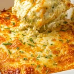 Hearty easy chicken enchilada casserole with melted cheese and vibrant toppings