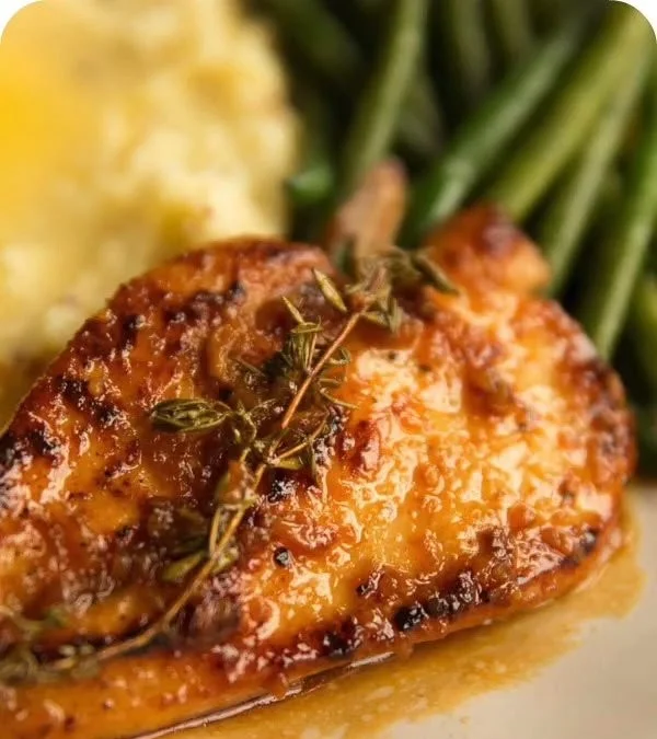 Delicious Honey Garlic Chicken Breasts served with herbs and vegetables
