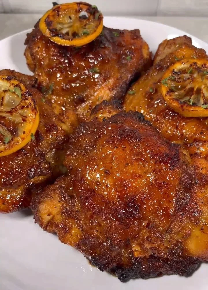 Succulent Honey Garlic Lemon Pepper Chicken Thighs garnished with herbs