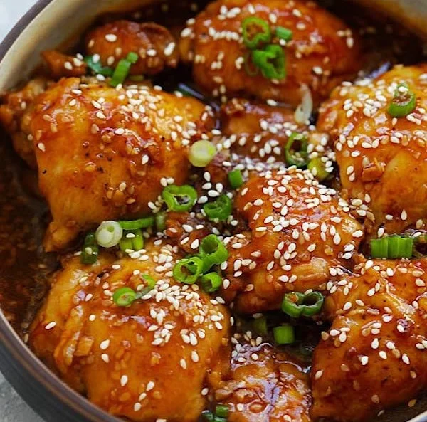 Honey sesame chicken thighs with sesame seeds and garnish