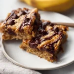 Healthy peanut butter banana bars on a wooden table