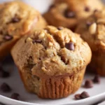 Freshly baked Peanut Butter Banana Muffins on a wooden table