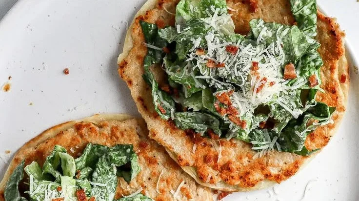 Smash Chicken Caesar Tacos with lettuce, chicken, and Caesar dressing