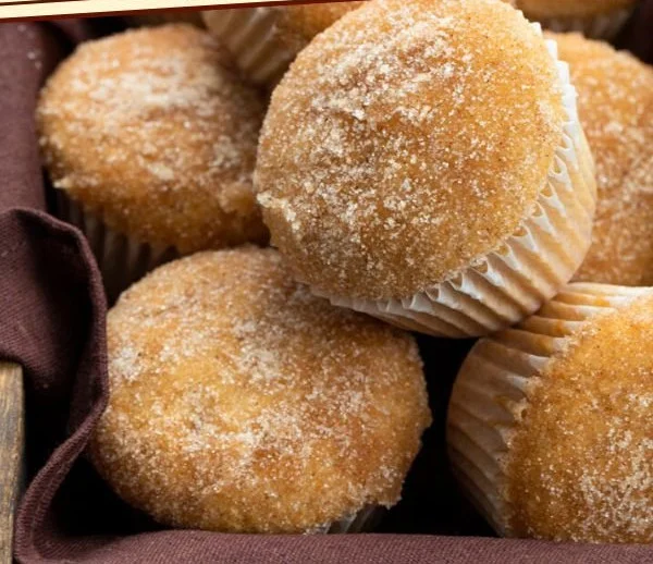 Freshly baked apple cider muffins topped with a sprinkle of cinnamon