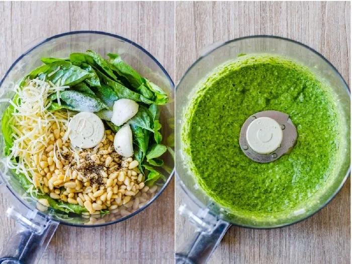 Bowl of fresh basil pesto made with basil leaves, pine nuts, and olive oil.