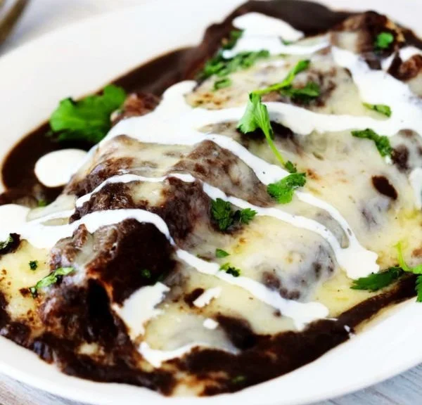 Delicious homemade bean enchiladas served with fresh toppings