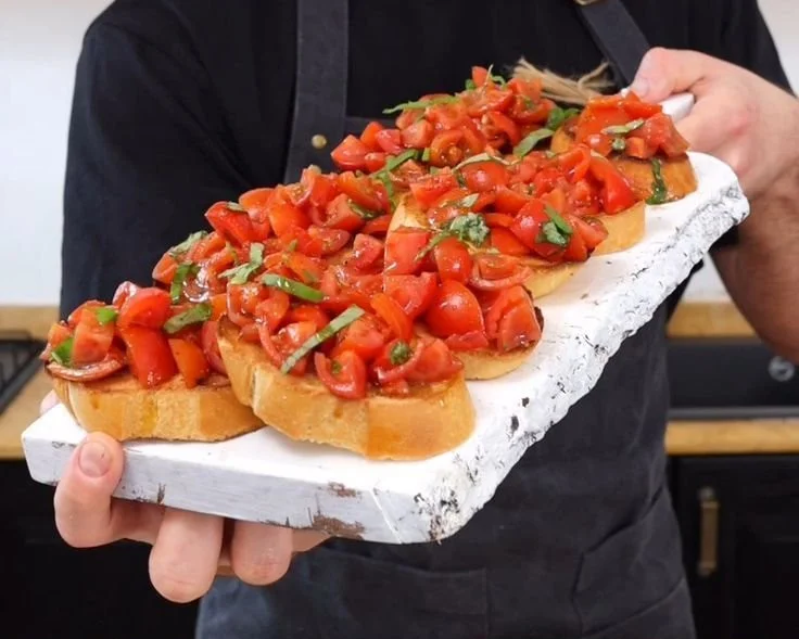 Colorful bruschetta topped with tomatoes, basil, and mozzarella on toasted bread