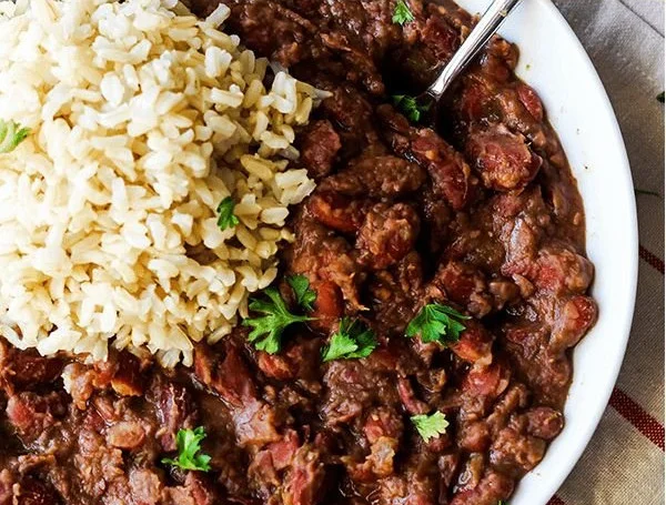 Cajun-Style Vegan Red Beans and Rice served in a bowl with herbs and spices