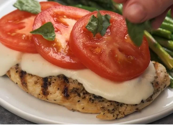 Delicious Caprese Chicken with fresh mozzarella, basil, and tomatoes