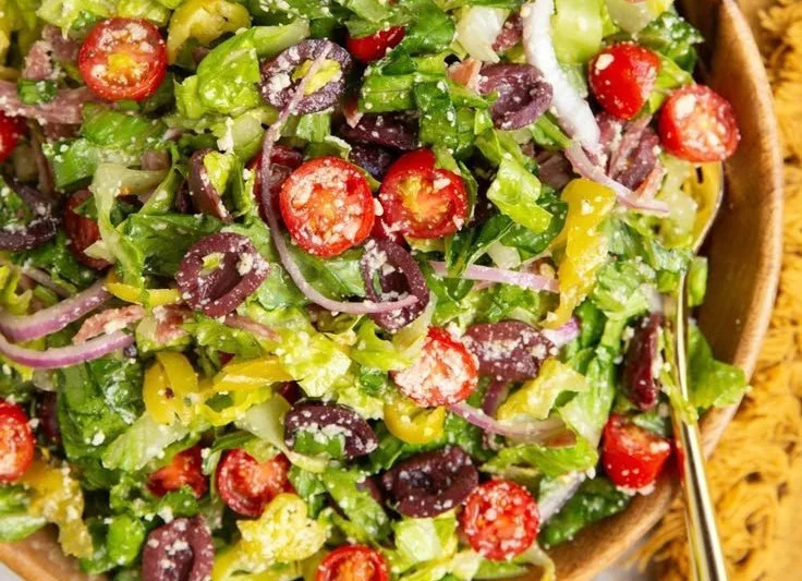 A colorful Classic Italian Salad with fresh vegetables and dressing.