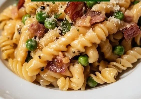 Creamy pasta with peas and pancetta in a bowl garnished with parsley.
