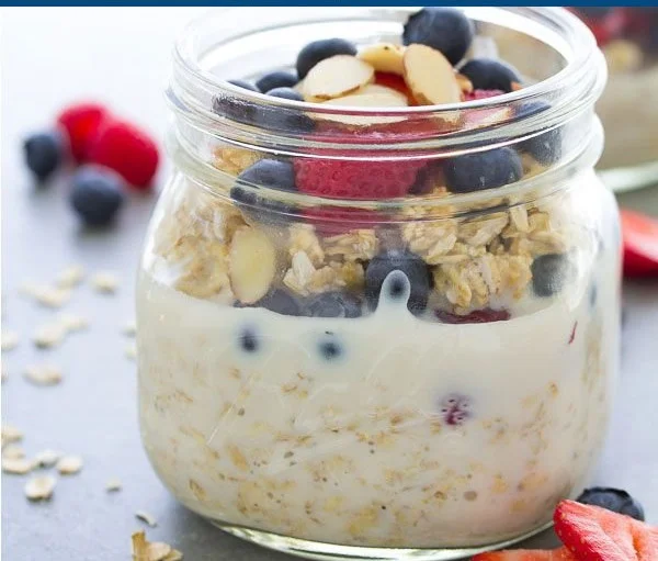 Bowl of easy overnight oats topped with fruits and nuts for a nutritious breakfast