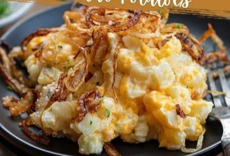 Baked French onion funeral potatoes topped with cheese and breadcrumbs