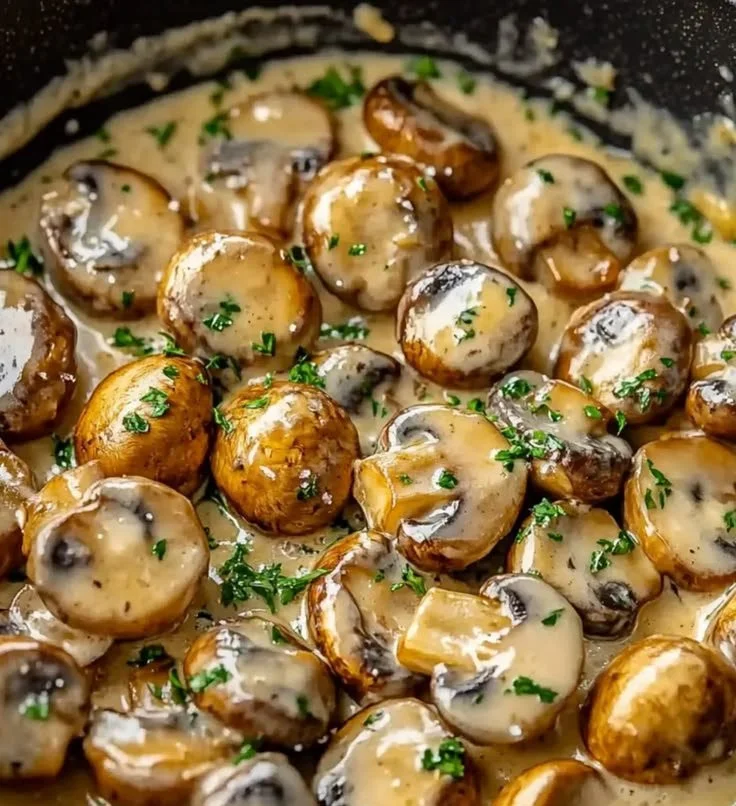 Close-up of garlic parmesan sautéed mushrooms in a skillet