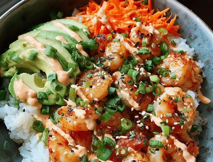 Delicious Garlic Shrimp Rice Bowls with Spicy Mayo garnished with herbs