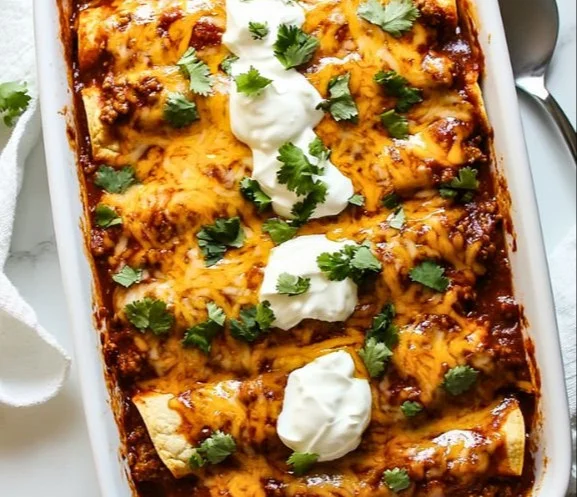 Delicious ground beef enchiladas topped with cheese and sauce
