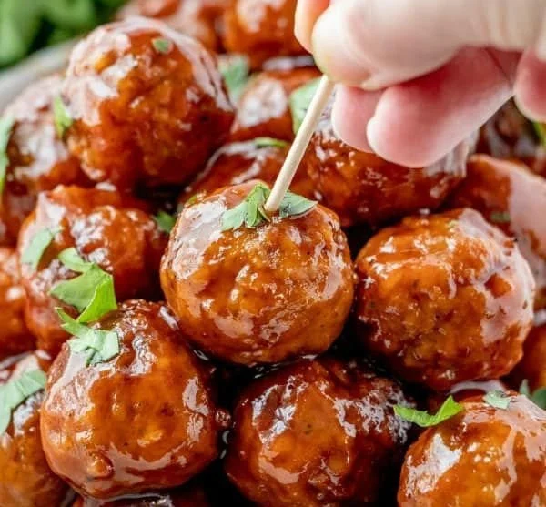 Delicious honey BBQ crockpot meatballs served on a platter.