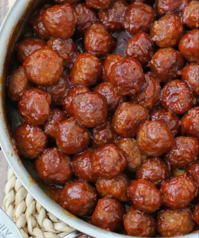 Plate of honey garlic meatballs glazed with sauce, garnished with green onions