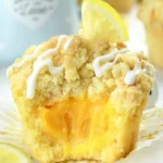 Lemon Curd Muffins 3 Freshly baked lemon curd muffins on a plate