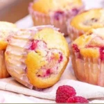 Freshly baked Lemon Raspberry Muffins on a wooden table