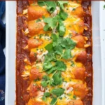 Delicious Mexican chicken enchiladas topped with cheese and fresh cilantro