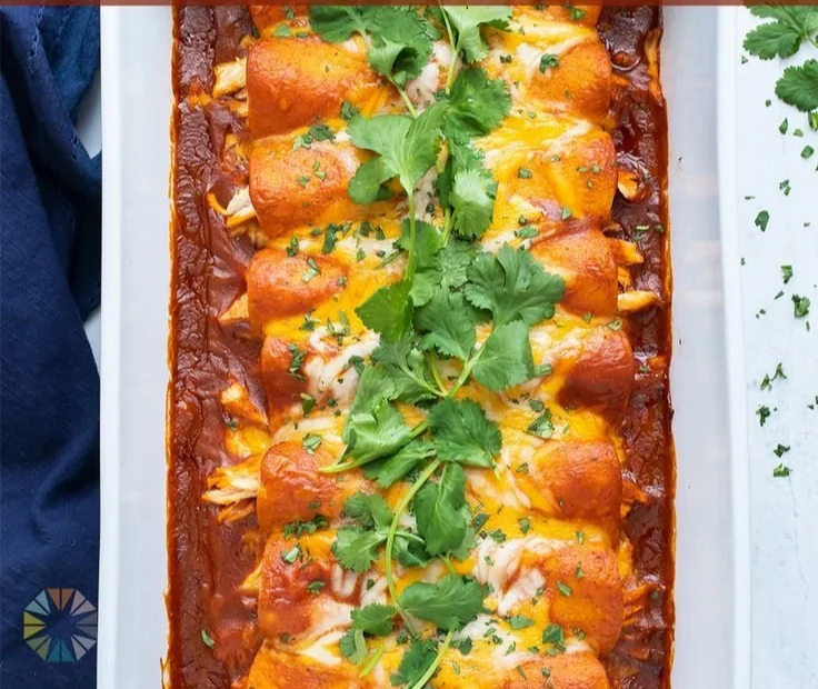 Delicious Mexican chicken enchiladas topped with cheese and fresh cilantro