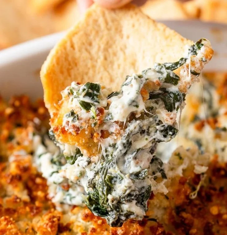 Parmesan Crusted Spinach Dip served in a dish, garnished with herbs.