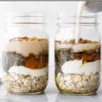 Bowl of pumpkin pie overnight oats topped with whipped cream and spices