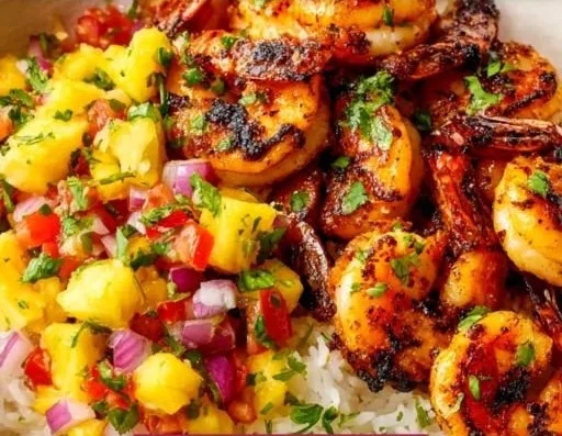 A colorful shrimp rice bowl with fresh vegetables and perfectly cooked rice