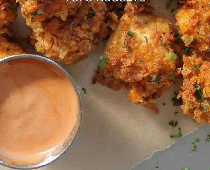 Plate of spicy popcorn tofu nuggets served with dipping sauce