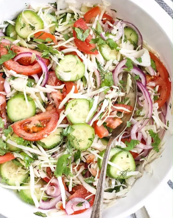 Colorful and fresh spring salad with seasonal vegetables and dressing.