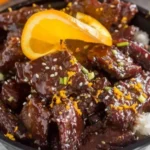 Sticky Orange Beef 3 Delicious serving of sticky orange beef with vibrant orange sauce