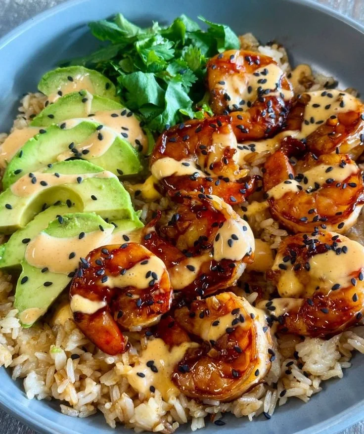 Delicious teriyaki shrimp rice bowls garnished with fresh vegetables
