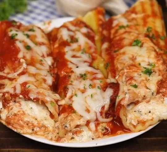Delicious Three Cheese Manicotti filled with ricotta, mozzarella, and parmesan cheese
