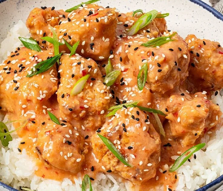 Crispy vegan bang bang cauliflower wings drizzled with spicy sauce