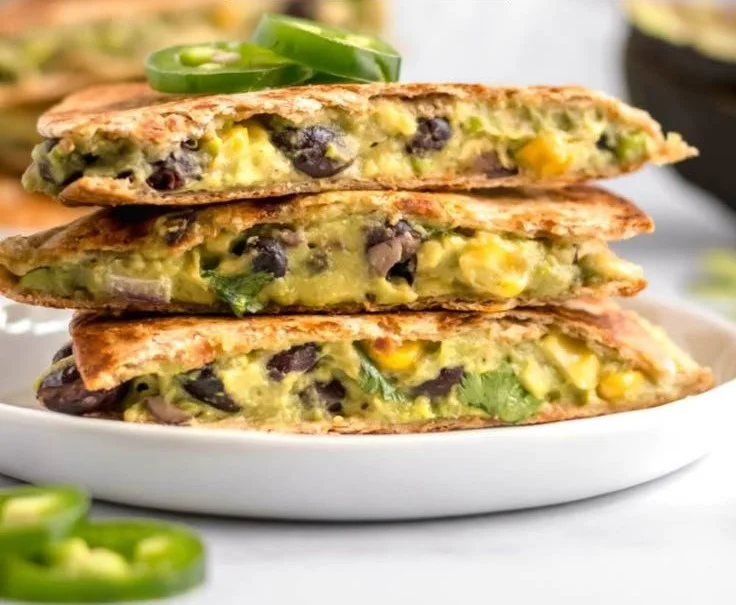 Vegan quesadillas with black beans and avocado on a plate