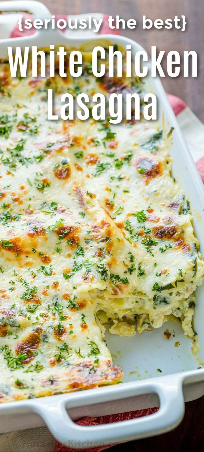 Delicious cheesy chicken lasagna topped with fresh herbs and melted cheese