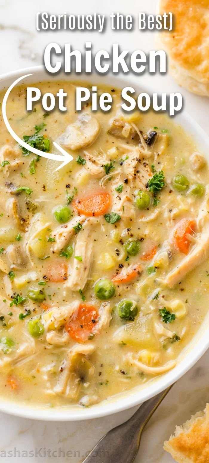 Bowl of creamy Chicken Pot Pie Soup topped with herbs and vegetables.