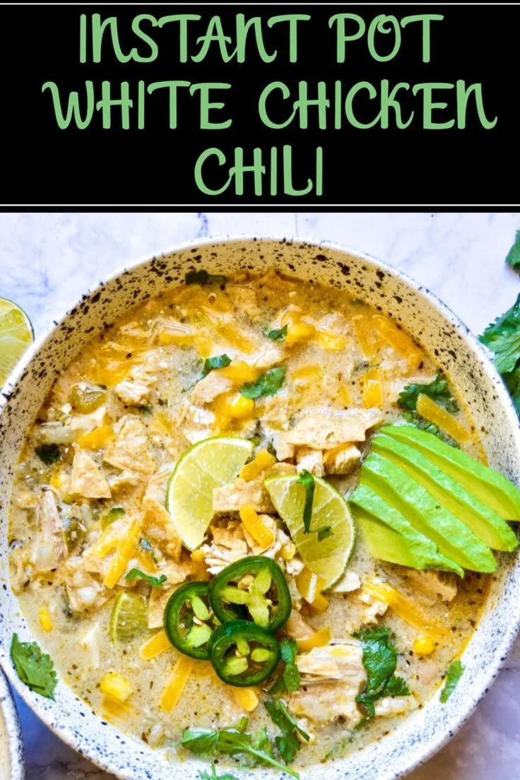 Bowl of Instant Pot white bean chicken chili topped with cilantro and served with bread