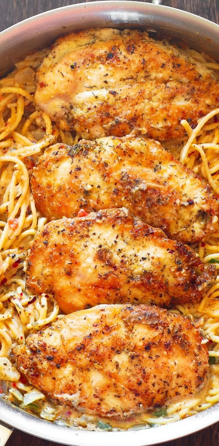Italian chicken pasta with creamy white wine parmesan cheese sauce served in a bowl